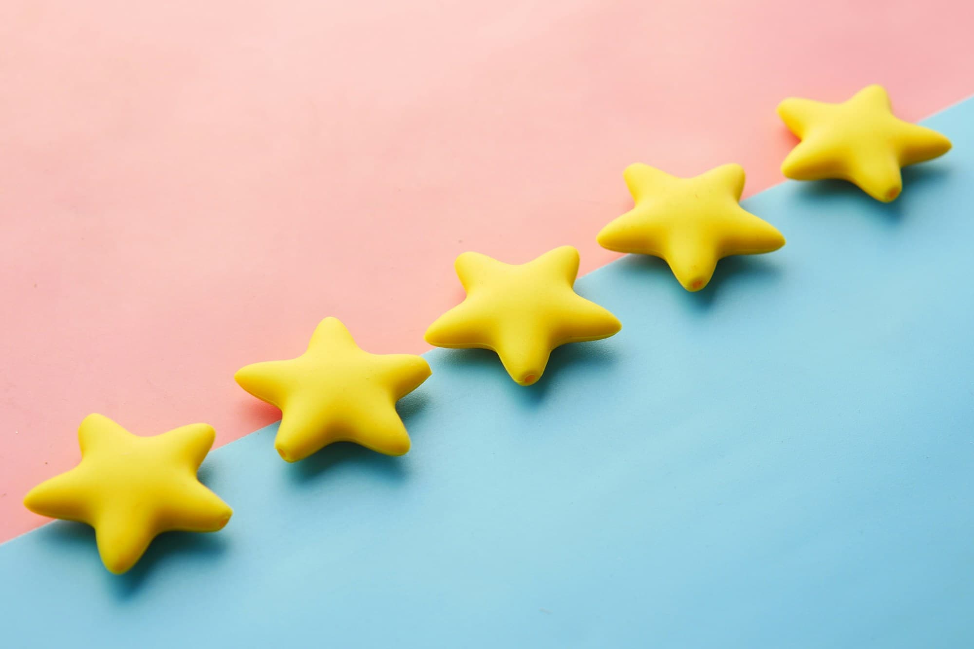 Cinco estrellas amarillas en fila sobre un fondo de colores